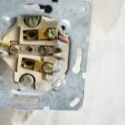 An electrical socket opened up to show its wiring