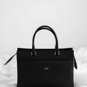A black leather handbag photographed for a classified listing