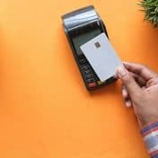 A card held up to a payment terminal